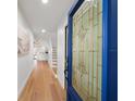 Inviting foyer with hardwood floors and a blue stained-glass front door at 5011 S Elberon St, Tampa, FL 33611