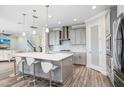 Spacious kitchen with a large island, pendant lighting, and sleek stainless steel appliances, perfect for modern living at 5407 Tagalong Pl, Apollo Beach, FL 33572