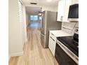 View of the modern kitchen with stainless steel appliances and wood floors at 5880 38Th N Ave # 107, St Petersburg, FL 33710