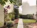 Pathway between buildings lined with colorful foliage and plants at 700 Starkey Rd # 821, Largo, FL 33771