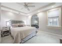 A bright bedroom featuring a large bed, stylish bedside tables, and a decorative archway at 107 S Obrien St # 117, Tampa, FL 33609