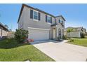 Beautiful home featuring an attached two car garage, manicured lawn, and quaint front entrance at 11218 Sage Canyon Dr, Riverview, FL 33578