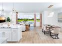 Open concept living and dining room with a view of the backyard, pool and lake at 11795 Starbright Path, Venice, FL 34293