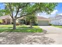 Attractive one-story home boasting mature landscaping, a well-kept lawn, and a convenient two-car garage at 16843 Harrierridge Pl, Lithia, FL 33547