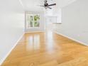Bright, empty living room with hardwood floors and large windows offering ample natural light at 1810 E Palm Ave # 6104, Tampa, FL 33605