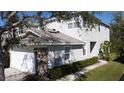 Two-story home featuring a two-car garage, stone accents, and manicured front lawn at 19227 Stone Hedge Dr, Tampa, FL 33647