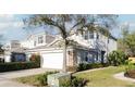 Two-story home boasts a two-car garage, stone accents, and meticulously maintained landscaping at 19227 Stone Hedge Dr, Tampa, FL 33647