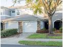 Charming townhome featuring a two-car garage and beautifully maintained landscaping at 19279 Stone Hedge Dr, Tampa, FL 33647
