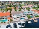 Aerial view of a neighborhood home with a private pool, spa, and dock on the water at 3545 Seaway Dr, New Port Richey, FL 34652