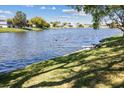 Scenic view of the community pond featuring a bench and a pair of ducks taking flight at 3553 Delta Pl, Holiday, FL 34691