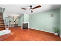 Bright living room featuring wood floors and a fireplace, open to dining and kitchen at 5704 Bratton Dr # 2, Tampa, FL 33617