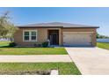 Charming single Gathering home with a well manicured lawn and two car garage at 733 Garden Oaks Sq, Seffner, FL 33584