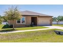 Charming single Gathering home with a well manicured lawn and two car garage at 733 Garden Oaks Sq, Seffner, FL 33584