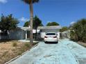 Exterior showcasing the blue driveway, garage, and mature trees at 9741 Scenic Dr, Port Richey, FL 34668