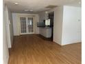Open floor plan featuring hardwood floors and view into the kitchen at 9741 Scenic Dr, Port Richey, FL 34668