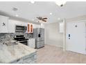 Modern kitchen features stainless steel appliances, light wood floors, and stylish backsplash at 100 Bluff View Dr # 409C, Belleair Bluffs, FL 33770