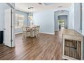 Open dining area featuring wood-look floors, modern lighting, and neutral wall paint at 11009 Silver Dancer Dr, Riverview, FL 33579
