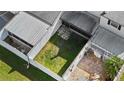 Aerial view of fenced backyards with patios and lawn space at 11918 Dietz Dr # 28, Tampa, FL 33626
