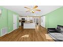 Bright, open-concept living room with hardwood floors, ceiling fans, and a charming central island at 11918 Dietz Dr # 28, Tampa, FL 33626