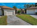 This property has a one-car garage, well-manicured lawn, and a cute, landscaped entryway at 1908 Bayshore Ct, Safety Harbor, FL 34695