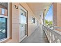 Hallway with a covered walkway, balcony and white door entry into unit 73 at 2457 Ecuadorian Way # 73, Clearwater, FL 33763