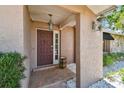 Inviting entryway features a brick landing, stylish lighting fixtures, and secure front door at 3034 Gull Pl, Clearwater, FL 33762
