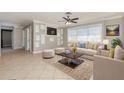 Bright living room with neutral décor, ceiling fan, and tile floors at 4 Oakland Hills Ct, Rotonda West, FL 33947