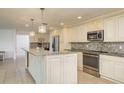 Stylish kitchen features stainless appliances, granite counters, and a large island at 4127 53Rd S Ave, St Petersburg, FL 33711