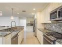Well-lit kitchen boasting stainless steel appliances and attractive granite countertops at 4127 53Rd S Ave, St Petersburg, FL 33711