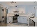 Renovated kitchen with stainless steel appliances and white marble countertops at 5020 Mill Pond Rd # 3158 & 3160, Wesley Chapel, FL 33543