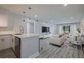 Open concept living space featuring updated kitchen, modern flooring, and plenty of natural light at 5020 Mill Pond Rd # 3158 & 3160, Wesley Chapel, FL 33543