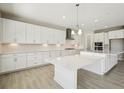 Bright kitchen with white cabinetry, modern stainless steel appliances, and a large center island at 5335 Wolf Creek Dr, Apollo Beach, FL 33572