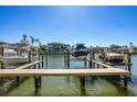 Waterfront property featuring a boat dock with boat lifts offering stunning views and convenient access to the water at 545 Pinellas Bayway S # 109, St Petersburg, FL 33715