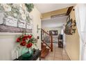 Inviting entryway featuring tile floors, wood staircase, and charming decor, creating a warm and welcoming ambiance at 716 Burlwood St, Brandon, FL 33511