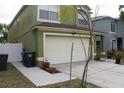 Side view of a home with a two-car garage and a well-kept lawn at 716 Burlwood St, Brandon, FL 33511