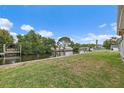 Lush backyard leading to the water with a dock, perfect for outdoor entertaining and enjoying waterfront living at 9101 Oak Ne St, St Petersburg, FL 33702