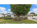 Charming single-story home with mature landscaping, a well-manicured lawn and attached garage at 9101 Oak Ne St, St Petersburg, FL 33702