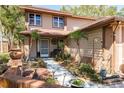 Inviting front yard with mature landscaping, a walkway to the front door, and beautiful curb appeal at 1888 Springbush Ln, Clearwater, FL 33763