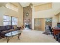 Bright living room features a brick fireplace, high ceilings, and sliding glass doors to the backyard at 1888 Springbush Ln, Clearwater, FL 33763