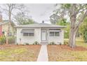 Quaint single-story home with a well-maintained lawn and mature trees offering shade at 2412 53Rd S St, Gulfport, FL 33707