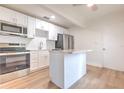Bright kitchen features stainless steel appliances, white cabinets, and a center island at 2412 53Rd S St, Gulfport, FL 33707