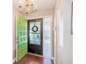 Inviting foyer with tile floors, a chandelier, and a bright green front door, adding a pop of color at 2507 Royal Pines Cir # 2H, Clearwater, FL 33763