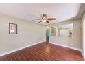 Cozy living room with wood-look floors, ceiling fan, and open view to other living spaces at 2507 Royal Pines Cir # 2H, Clearwater, FL 33763
