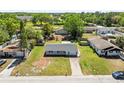 An aerial view of a cozy single-Gathering home with a well-maintained front yard at 3210 Acacia St, Lutz, FL 33558