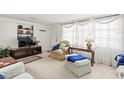 Comfortable living room featuring a TV, built-in shelves, and bright natural lighting at 3210 Acacia St, Lutz, FL 33558