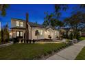 Exterior view of a two-story home at night with inviting landscape lighting at 346 16Th Ne Ave, St Petersburg, FL 33704