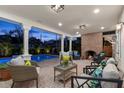 Outdoor patio with brick fireplace and comfortable seating overlooking a pristine pool at 346 16Th Ne Ave, St Petersburg, FL 33704