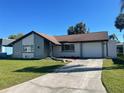 Beautiful single-Gathering home with a private driveway and a well-maintained green lawn at 3704 Haven Dr, New Port Richey, FL 34652