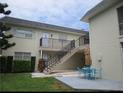 Charming condo building with a well-manicured lawn and outdoor seating area at 430 Larboard Way # 3, Clearwater Beach, FL 33767
