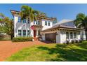 Charming home with a two-car garage, manicured lawn, and beautiful flowers, offering a warm and inviting atmosphere at 4605 W Vasconia St, Tampa, FL 33629